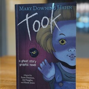 Scholastic Graphic Novel with Dark Purple and Red Cover